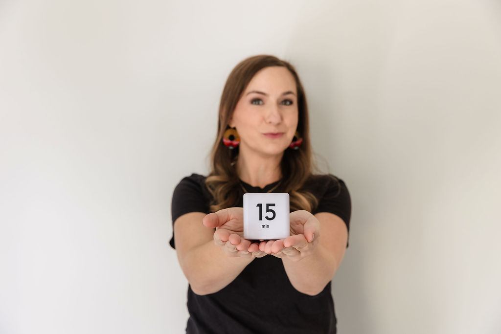 Woman holding 15 minute timer