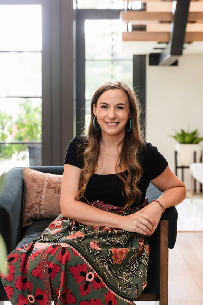 Woman sitting on chair and looking happy
