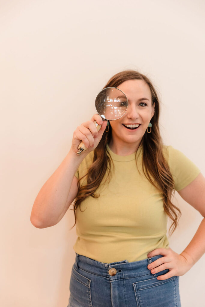 Woman looking through magnifying glass
